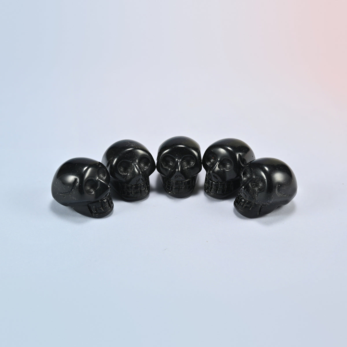 1 inch skull crystal carving in black obsidian, glossy black natural stone