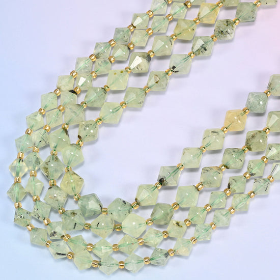 Green Prehnite faceted bicone beads, 8mm and 10mm, arranged in a loose curved loop on a light lavender background.