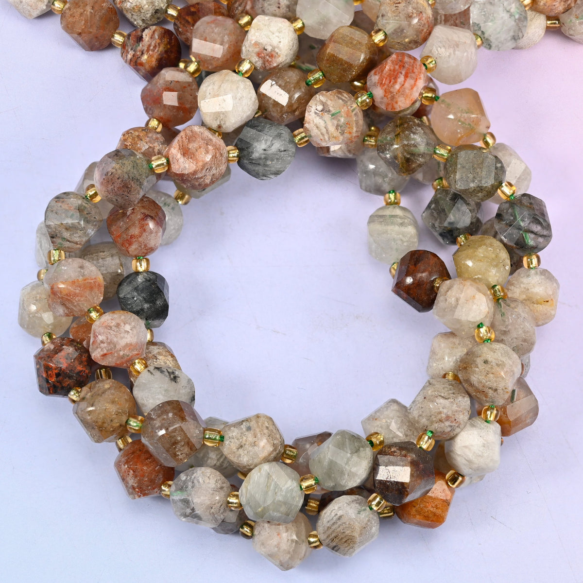 Natural thousand layer phantom quartz crystal beads in a 10mm faceted spiral twist cut