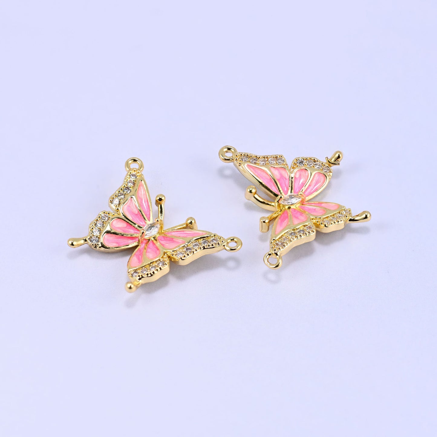Open wing butterfly pendants with blush pink enamel panels and pave zircon