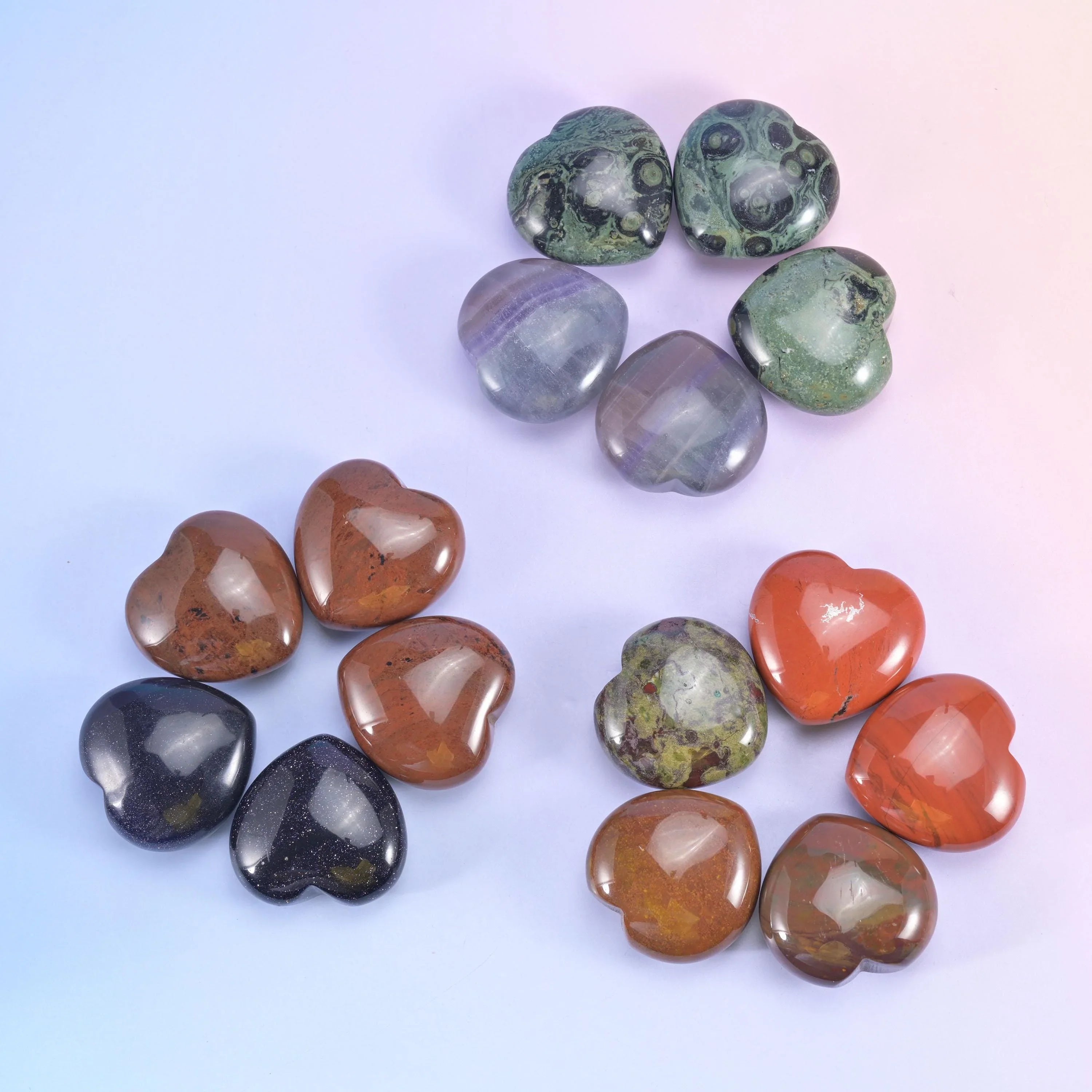 Loose arrangement on lilac, rust red, dark obsidian, olive and warm brown hearts side by side