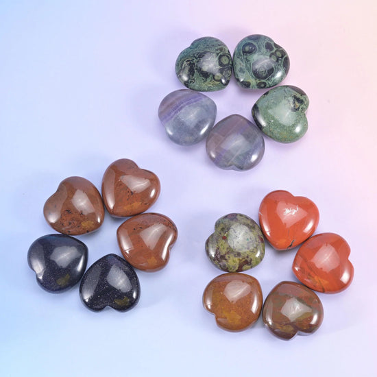 Loose arrangement on lilac, rust red, dark obsidian, olive and warm brown hearts side by side