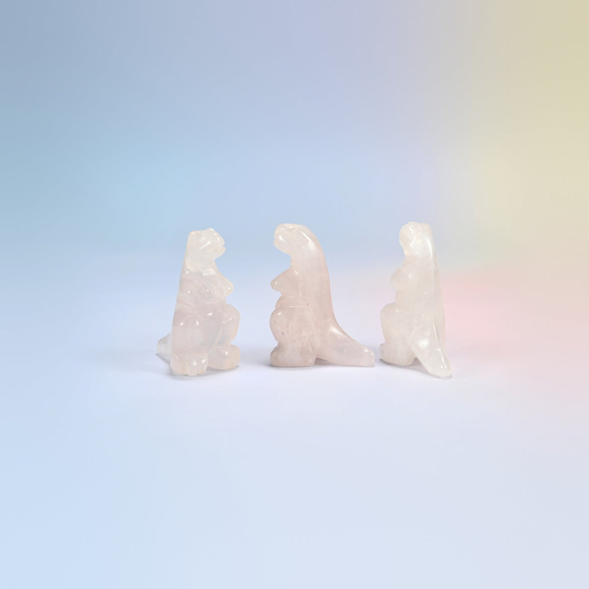 Three rose quartz T-Rex dinosaur crystal carvings, 2 inch, light pink natural stone