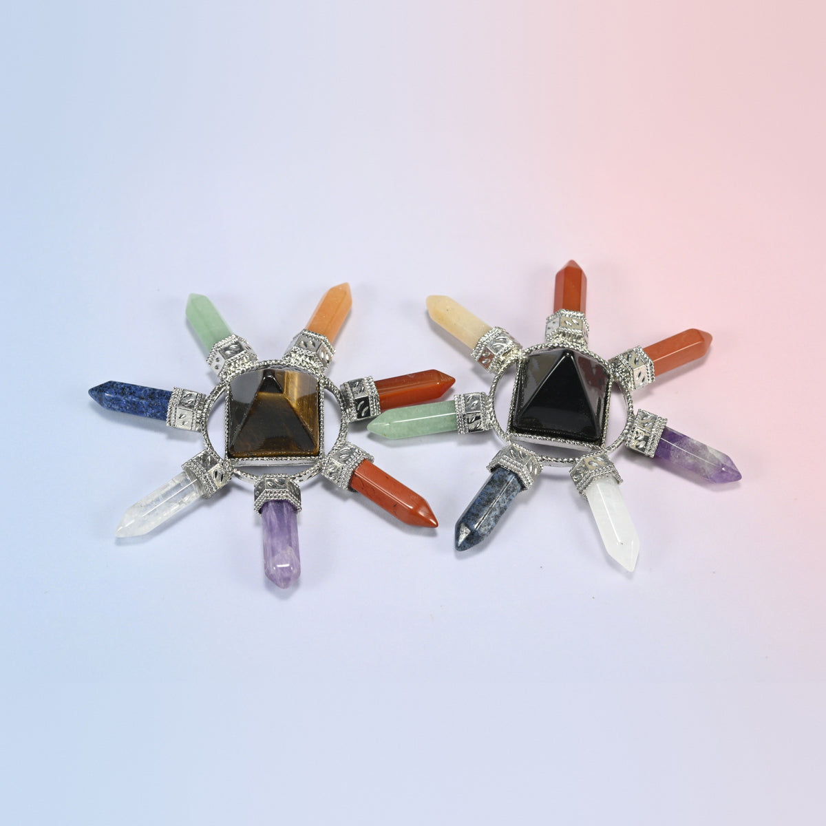 Two crystal energy generators with tiger eye and black obsidian center pyramids and seven chakra crystal points each