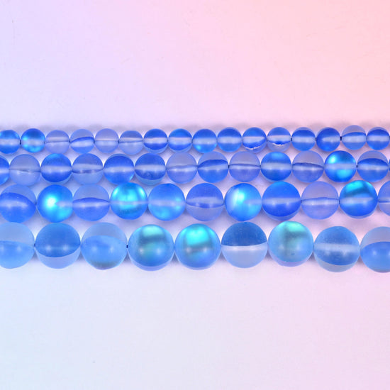 Mystic Aura Matte Blue Round Glass Beads in cornflower blue with a turquoise-and-gold aurora glow