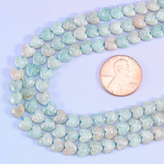 Amazonite heart beads looped beside a US penny for size comparison