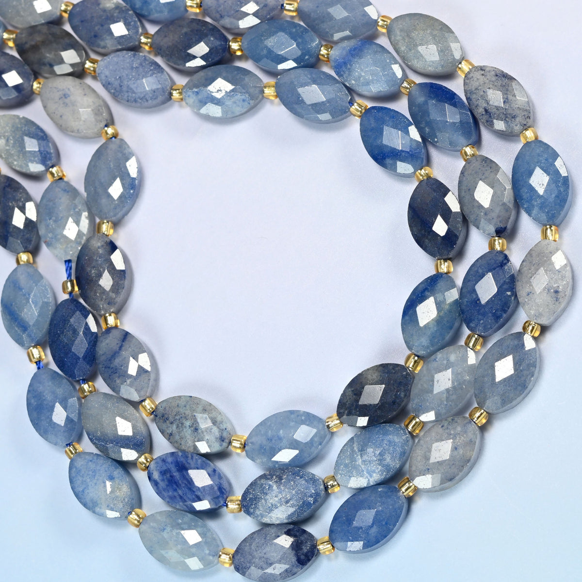 Blue aventurine faceted flat oval beads curved into an open loop, light and dark blue beads with a soft shimmer