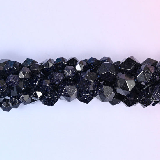 Close-up band of blue sandstone beads where the fine copper glitter flecks catch the light