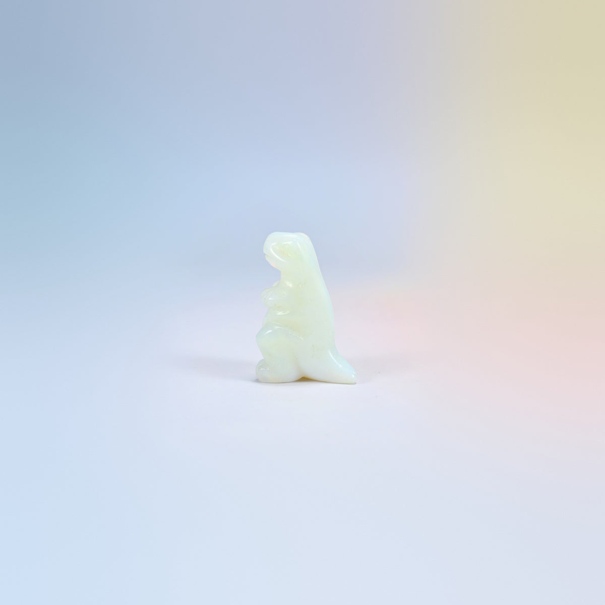 One opalite T-Rex dinosaur crystal carving, 2 inch, glowing milky white man-made glass