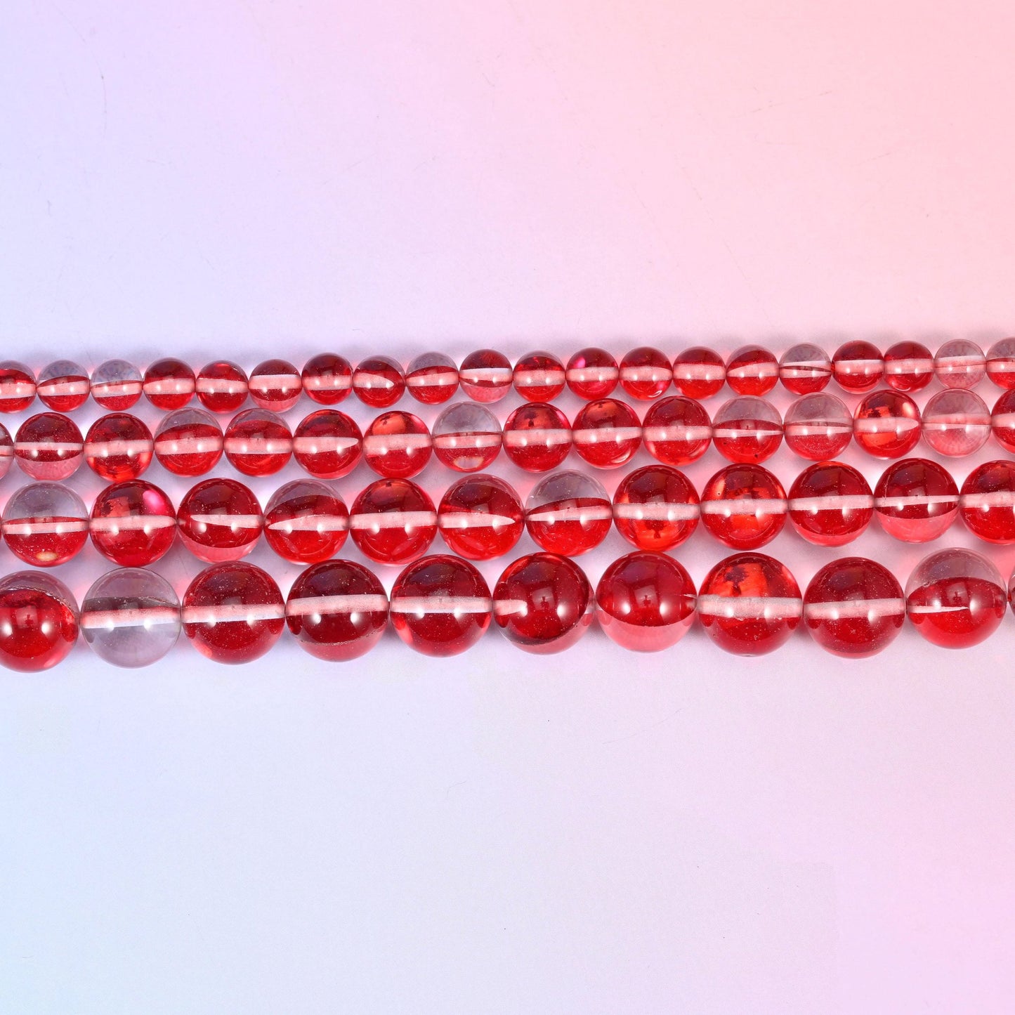 Mystic Aura beads in cherry red glass with a pale iridescent stripe