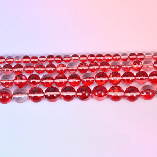 Mystic Aura beads in cherry red glass with a pale iridescent stripe