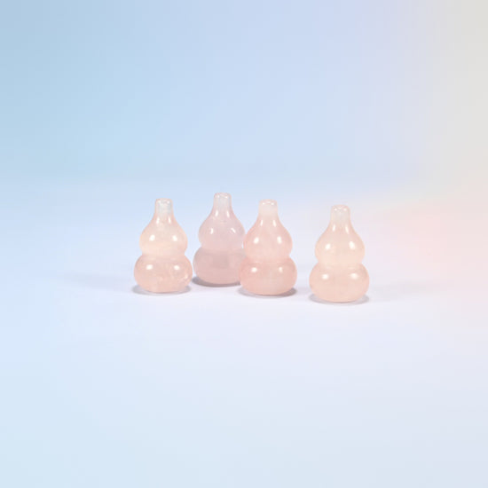 Four 1.2 inch natural rose quartz gourds side by side