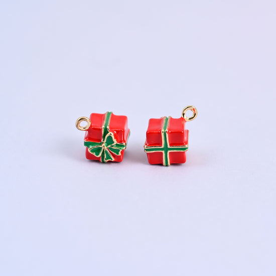 Two red gift box charms with green enamel ribbon and bow, front and back.