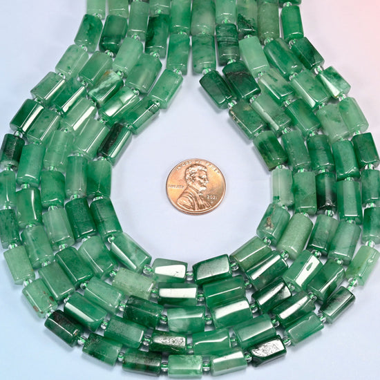 African jade faceted tube strands formed into a teardrop loop around a US penny for scale