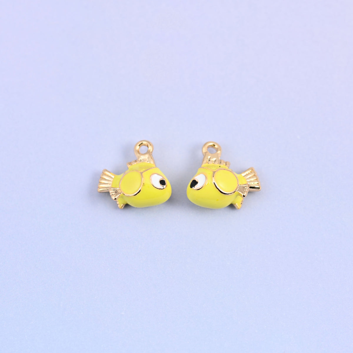 Two fish charms facing each other, showing the big black and white eye on each side.