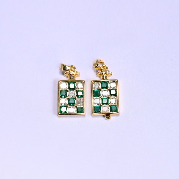 Green checkerboard version of the perfume bottle zirconia charm, two 18K gold plated pendants side by side, one turned slightly to show the bottle side profile.