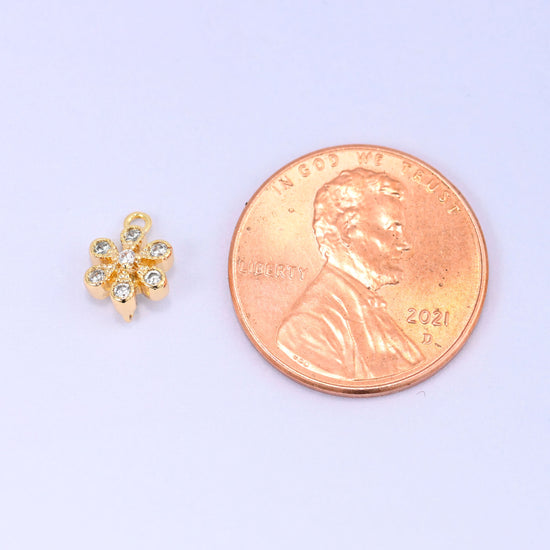 Small gold charms, one flower charm shown beside a US penny for size
