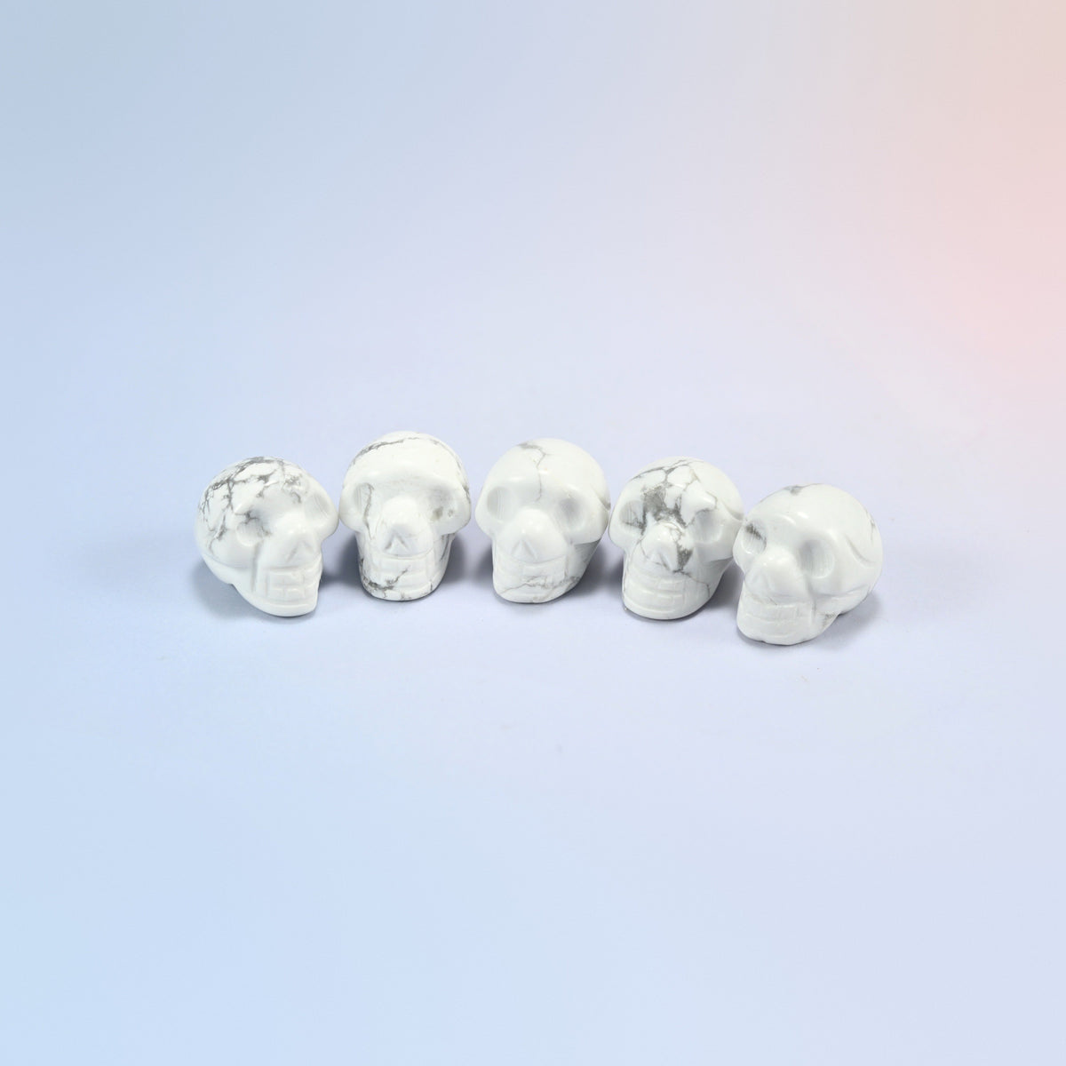 1 inch skull crystal carving in white howlite, white natural stone with gray veining