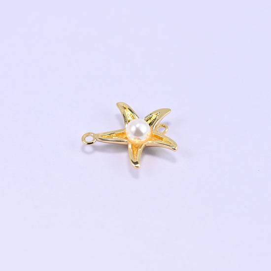 Softly rounded five-arm starfish in polished 18K gold plated brass with a round white pearl centre