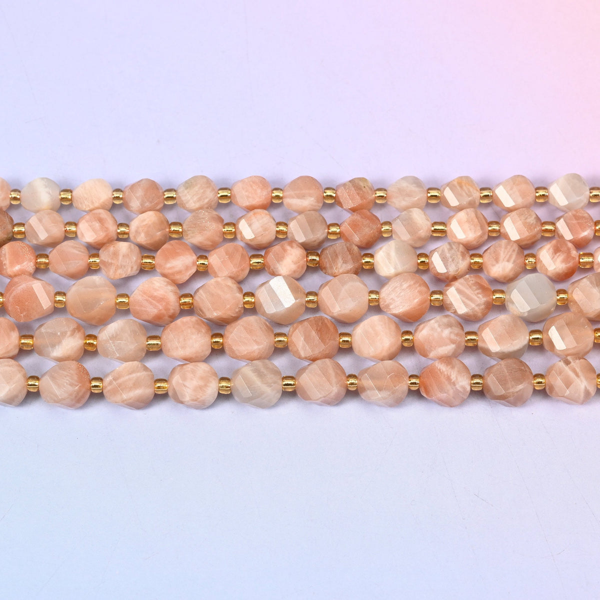 Orange Sunstone beads in warm peach-to-apricot with pale cream streaking