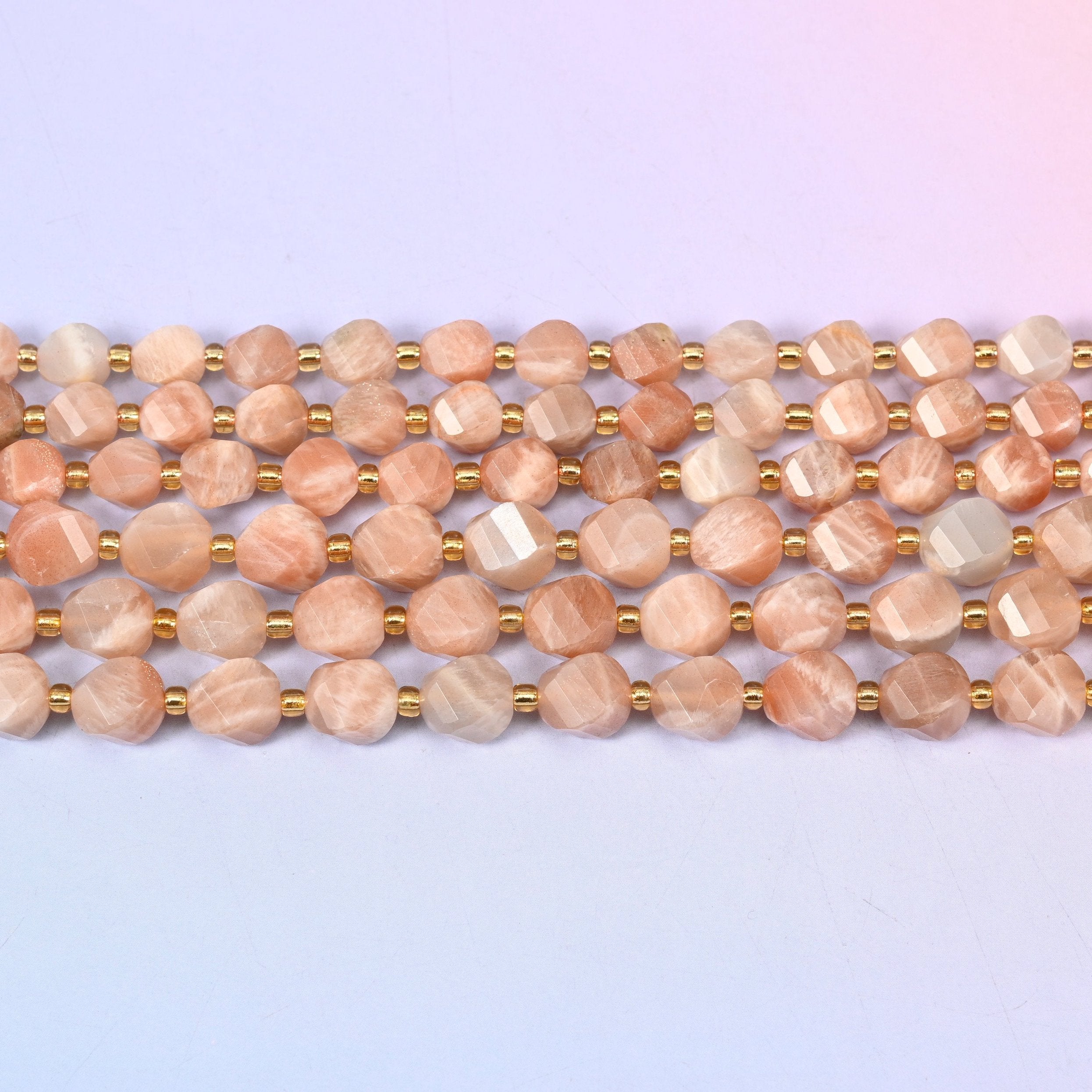 Orange Sunstone beads in warm peach-to-apricot with pale cream streaking