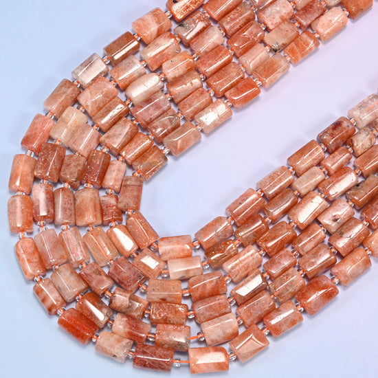 Circular coil of faceted Golden Strawberry Quartz tube bead strands on a lavender background.