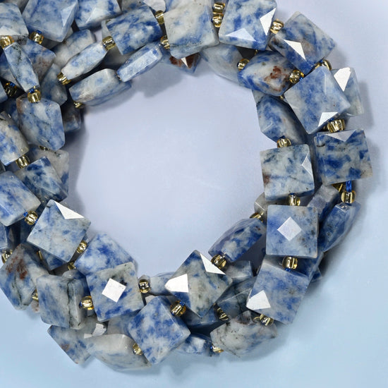 Natural blue spot jasper faceted flat square beads coiled into overlapping loops, whole strands of speckled blue and white stone