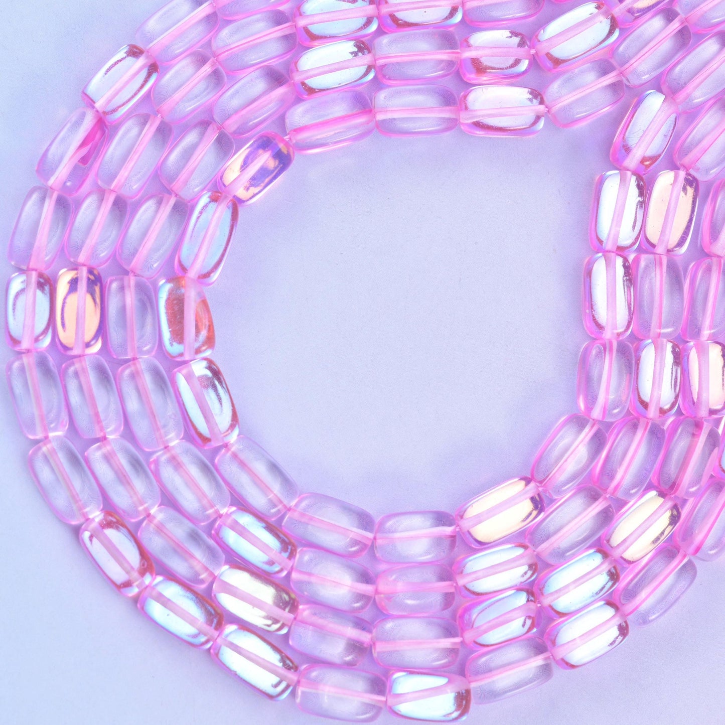 Pink mystic aura glass beads, approximately 34 beads per strand