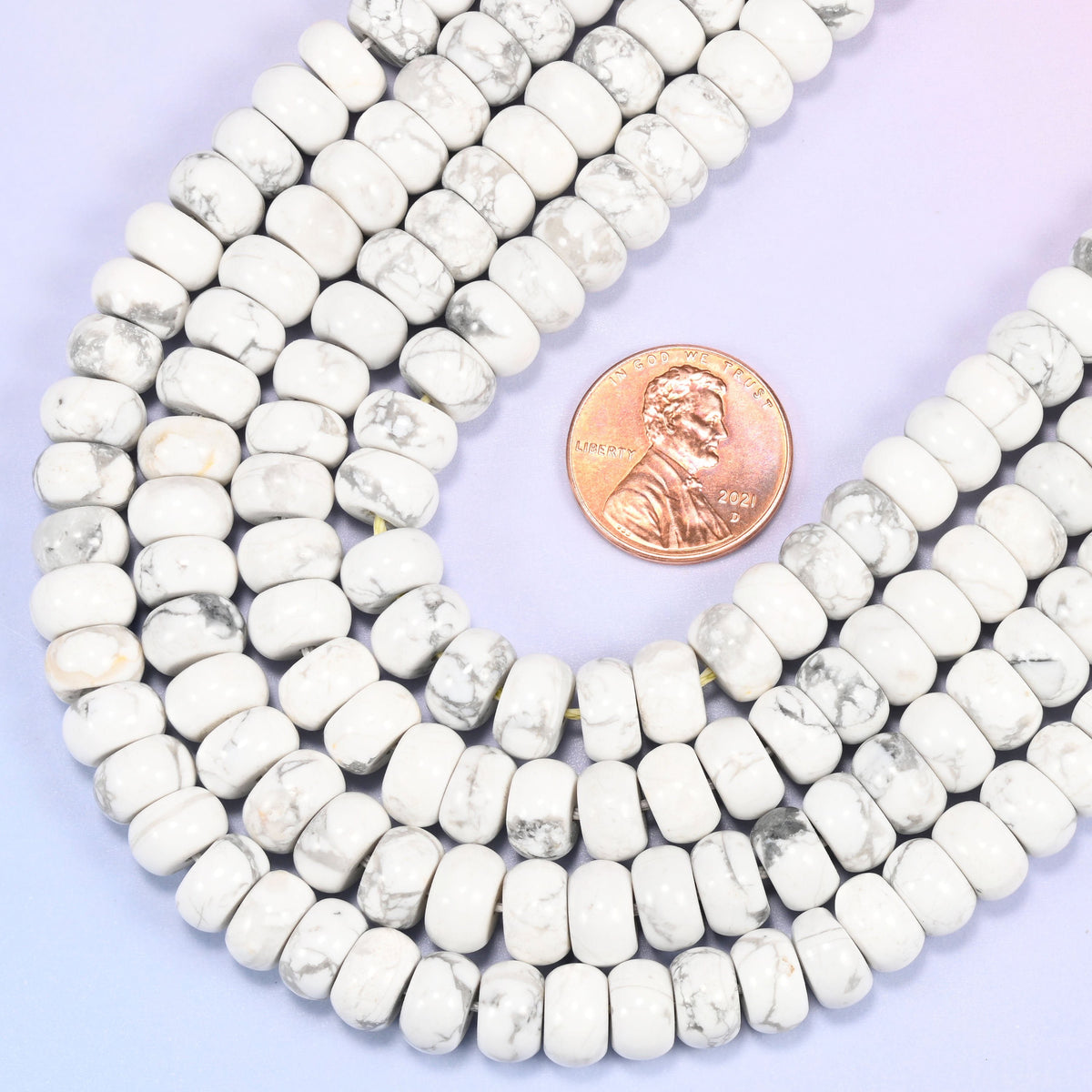 Rondelle cut Natural White Howlite beads with a classic marble-like look.