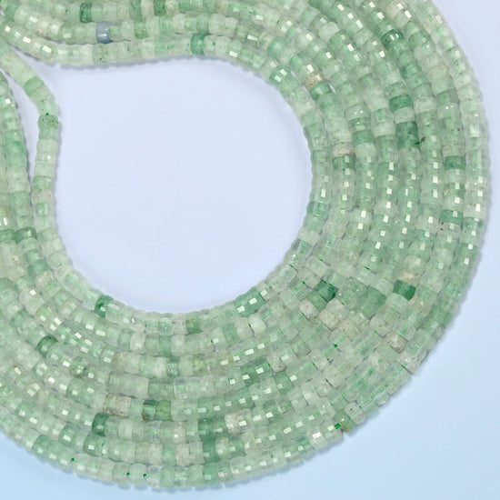 Green strawberry quartz faceted heishi disc beads curved into an open loop, light green beads with darker flecks