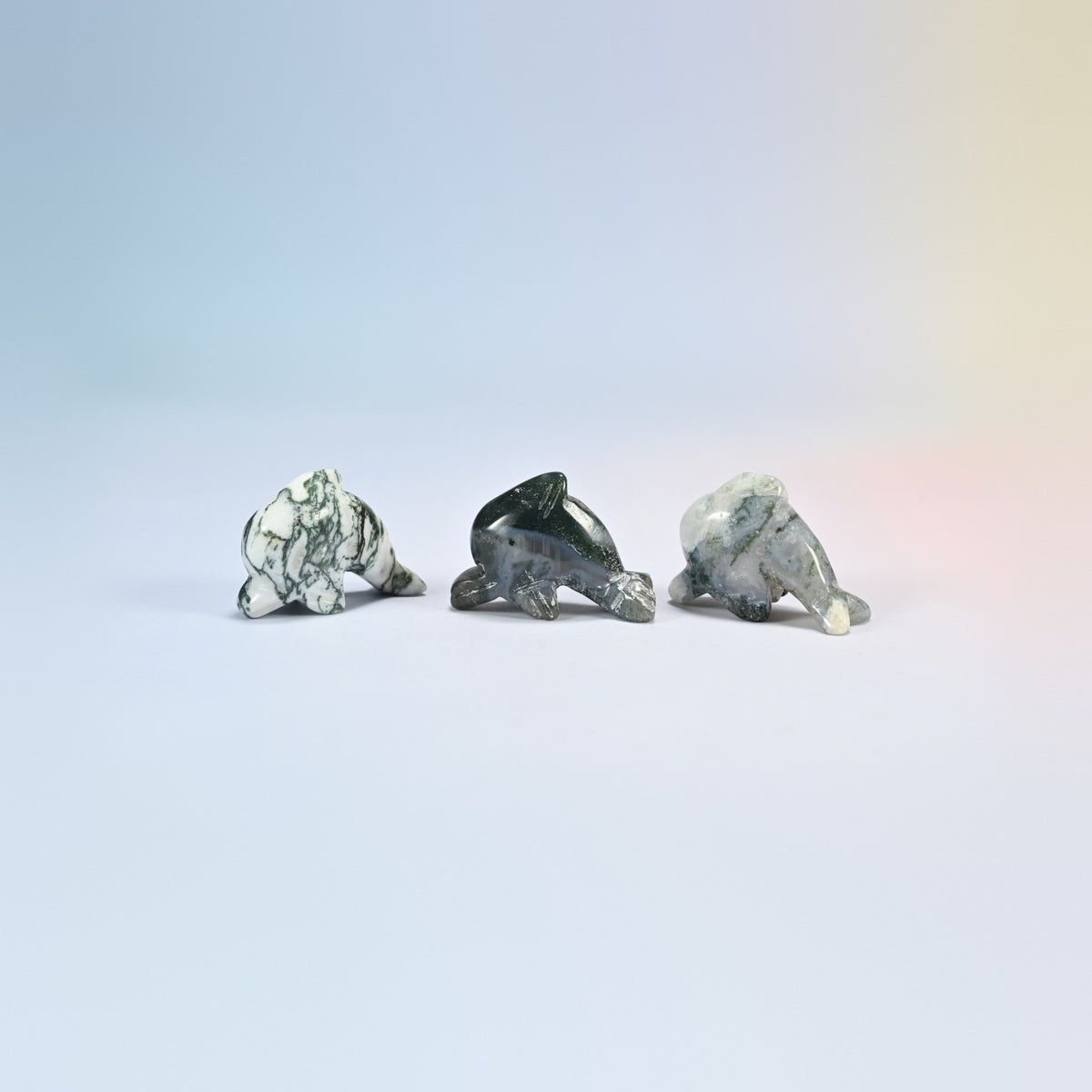 Three moss agate dolphin crystal carvings, 1.5 inch, white and green natural stone with dark inclusions