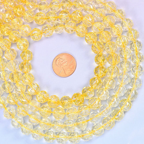 Transparent yellow faceted round glass beads, approximately 42 beads per strand
