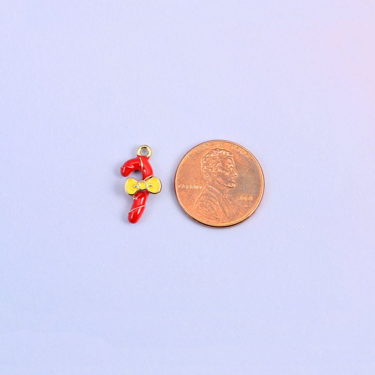 Candy cane charm shown for scale at 17.16 x 8.46mm, red enamel over 18K gold plated brass.