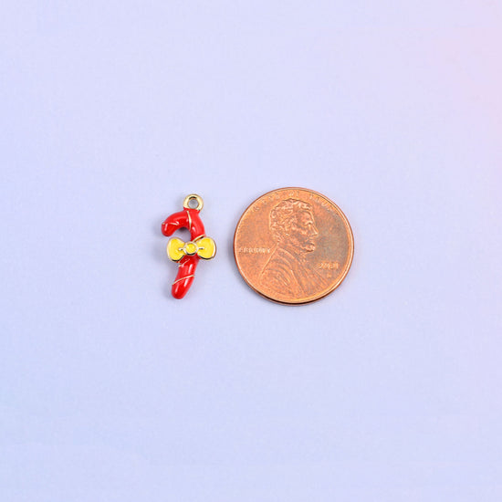 Candy cane charm shown for scale at 17.16 x 8.46mm, red enamel over 18K gold plated brass.
