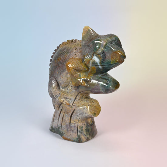 Ocean jasper chameleon carving from the right front, carved feet clasping the branch