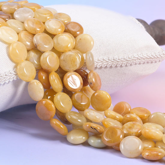 Natural Yellow Jade smooth coin beads in warm honey and butterscotch with cloudy cream centres