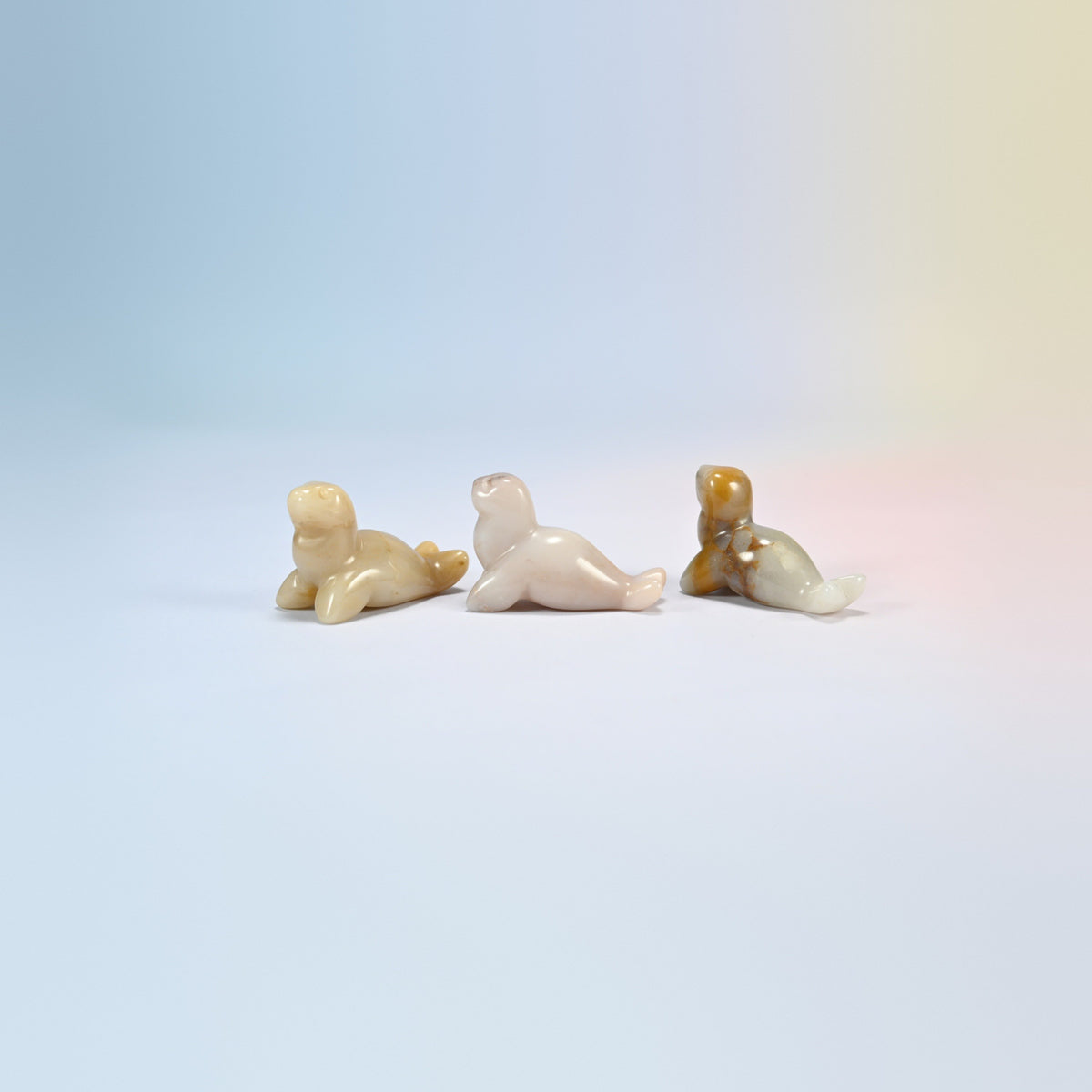 Three gray agate sea lion crystal carvings, 1.5 inch, cream, tan and gray natural stone