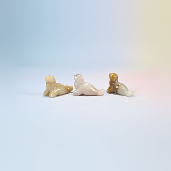 Three gray agate sea lion crystal carvings, 1.5 inch, cream, tan and gray natural stone