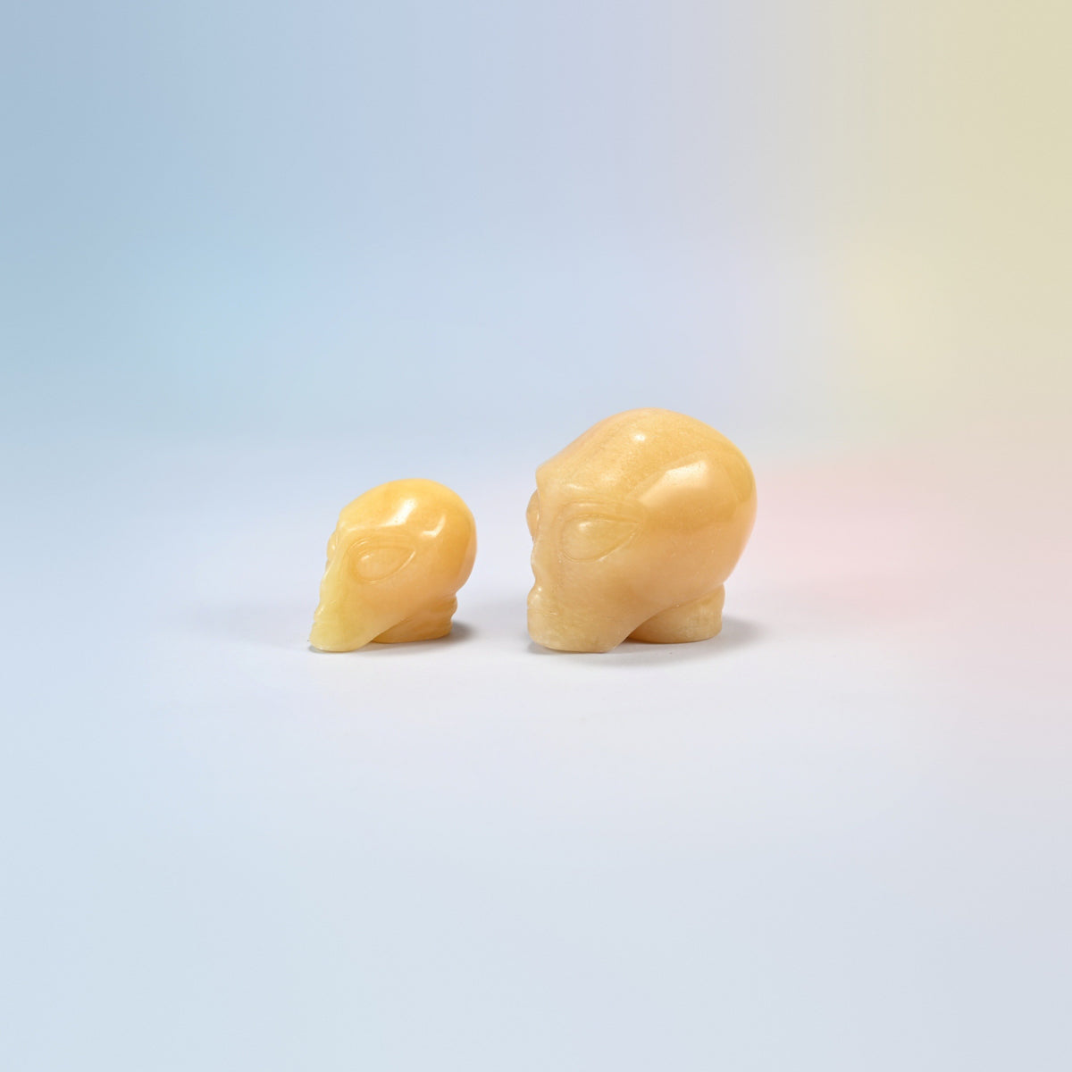 Two yellow jade alien head crystal carvings, 1.5 inch and 2 inch, honey yellow natural stone