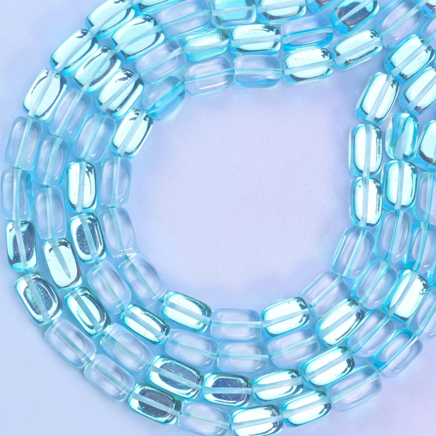 Light blue mystic aura glass beads, approximately 34 beads per strand