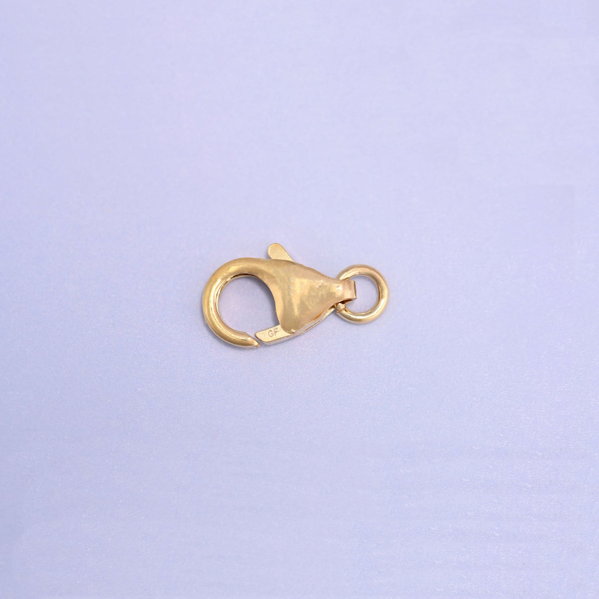 14K gold filled lobster clasp, 6x10mm, angled with the jump ring at the upper right and the stamped tab in view