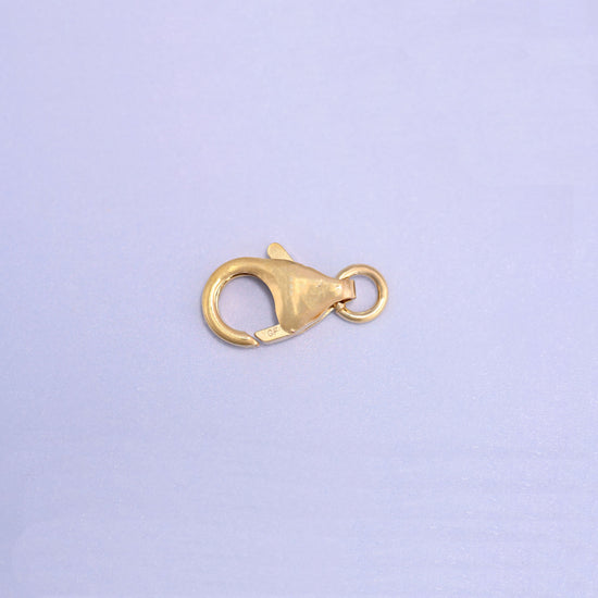 14K gold filled lobster clasp, 6x10mm, angled with the jump ring at the upper right and the stamped tab in view