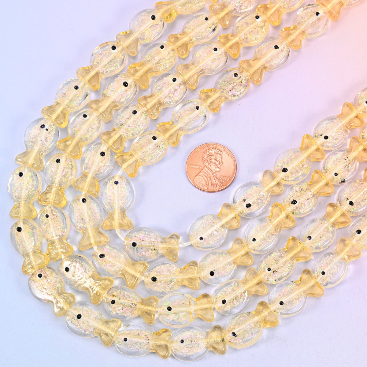 Fish shaped iridescent glass beads