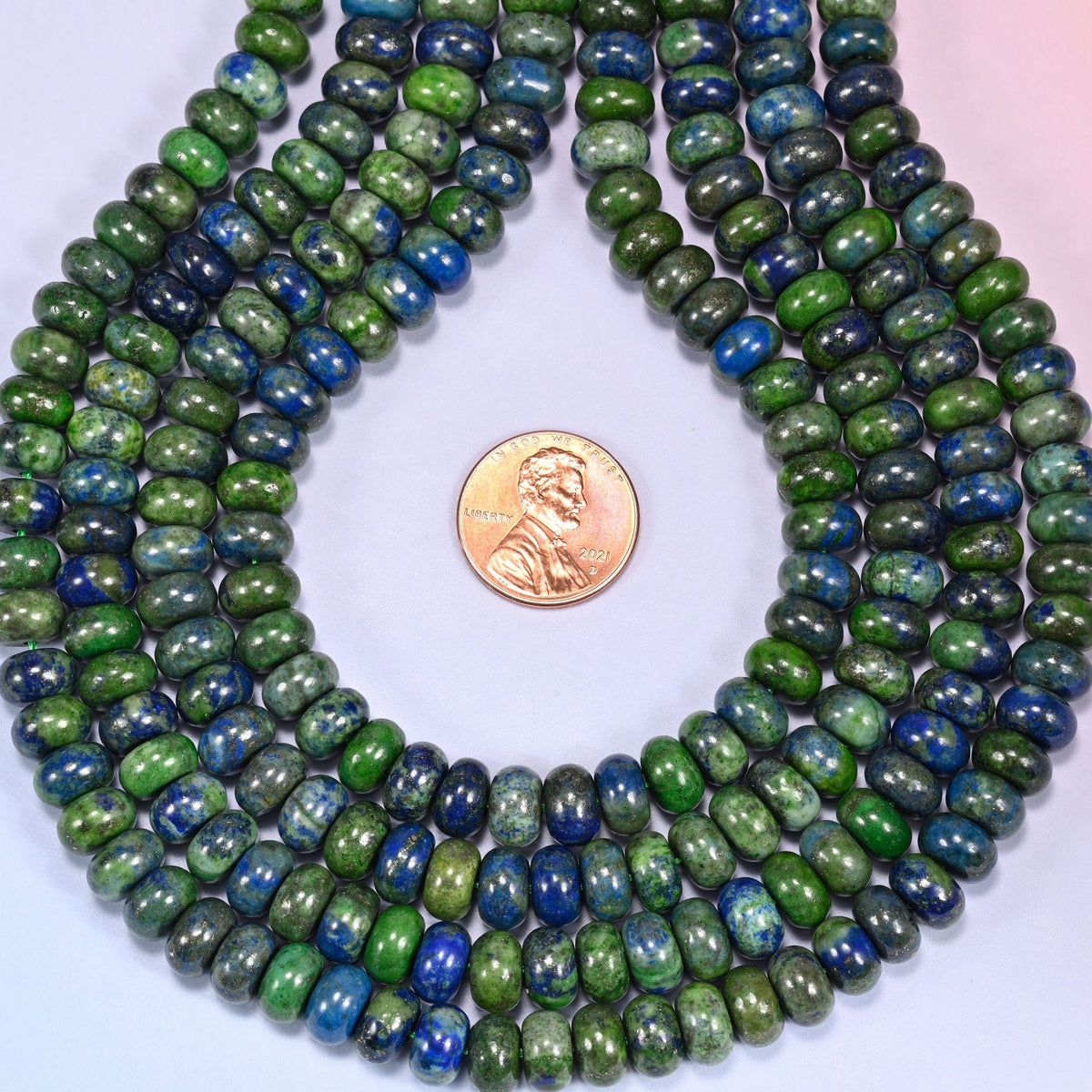 Natural Phoenix Lapis rondelle beads in a striking mix of deep blue and moss green with pyrite flecks.