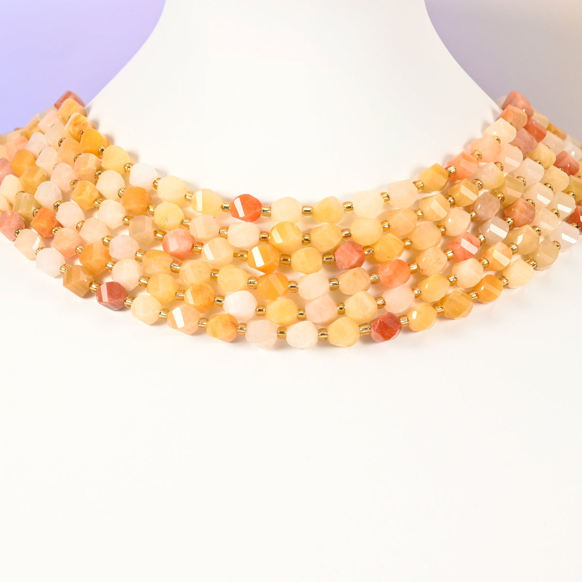 Gold silk jade yellow jade beads showing translucent honey yellow lit from within across the 8mm faceted beads