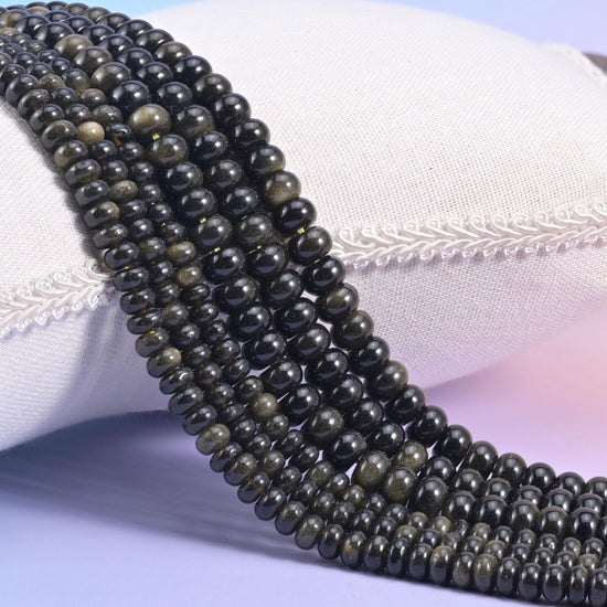 Natural Gold Obsidian smooth rondelle beads in deep glossy black with a striking golden sheen