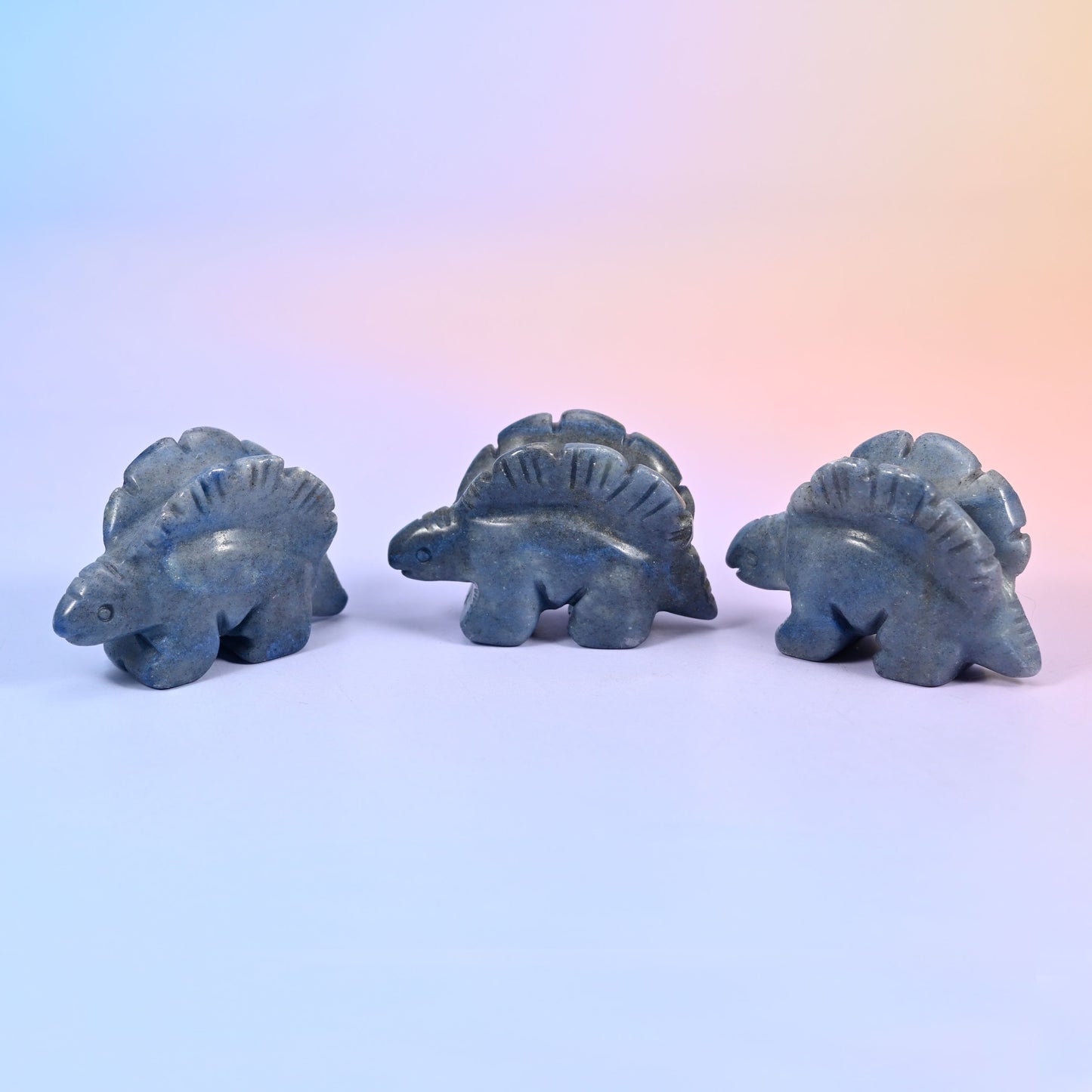 Stegosaurus carving offered in 12 natural stone options, from mint green and brick red to banded brown