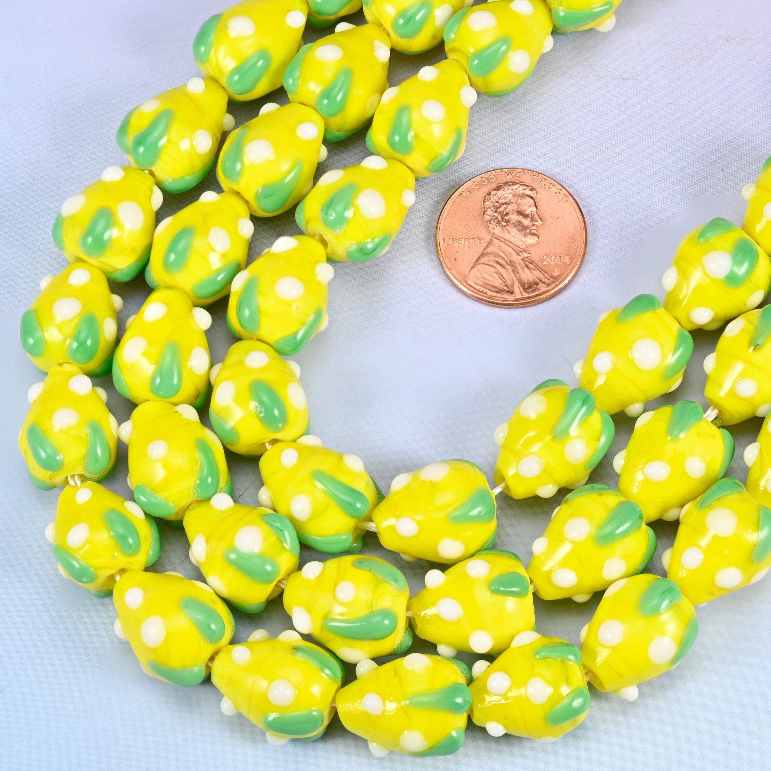 Strawberry shaped glass beads speckled with white seed dots