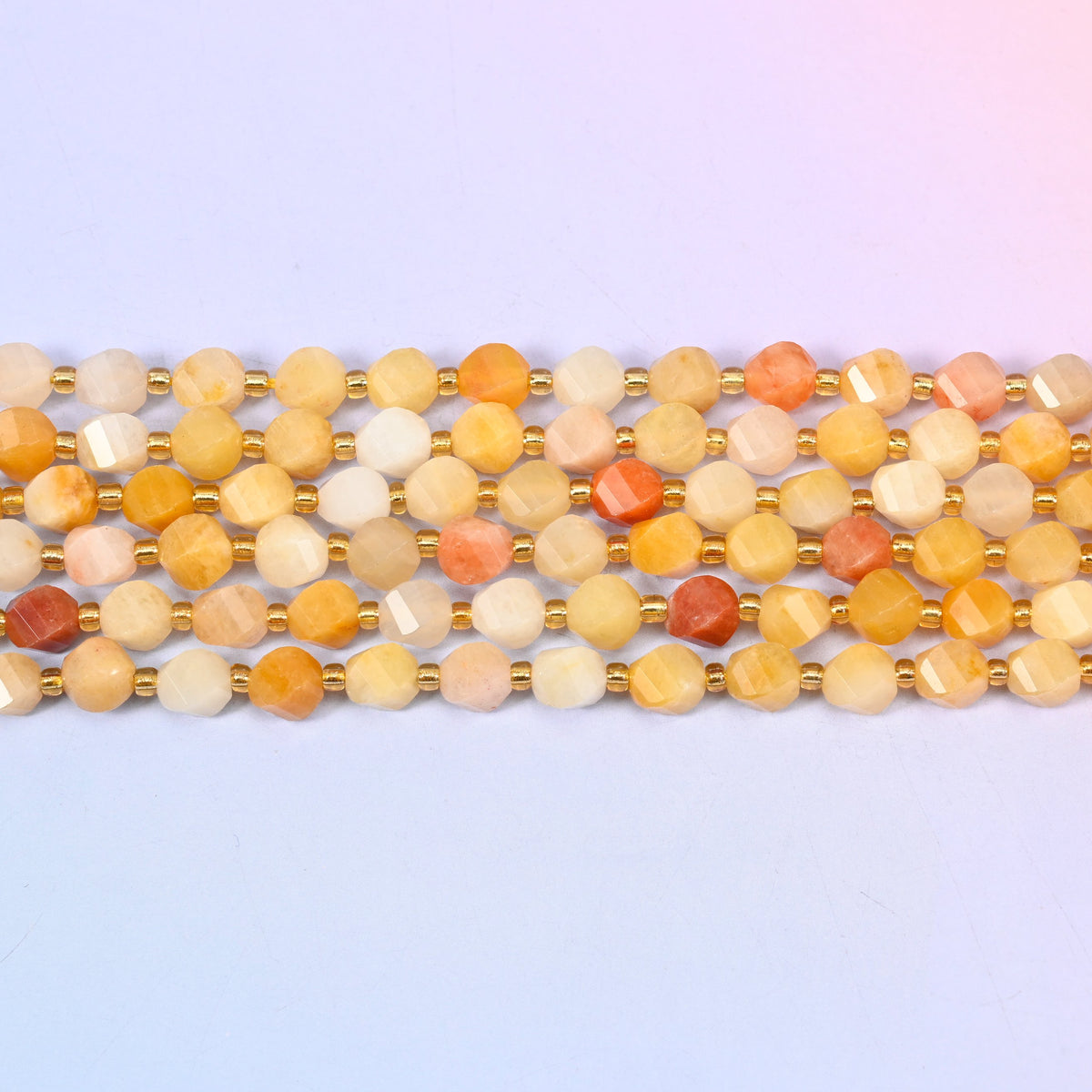 Gold silk jade yellow jade beads with peach and terracotta beads scattered through the warm yellow strand