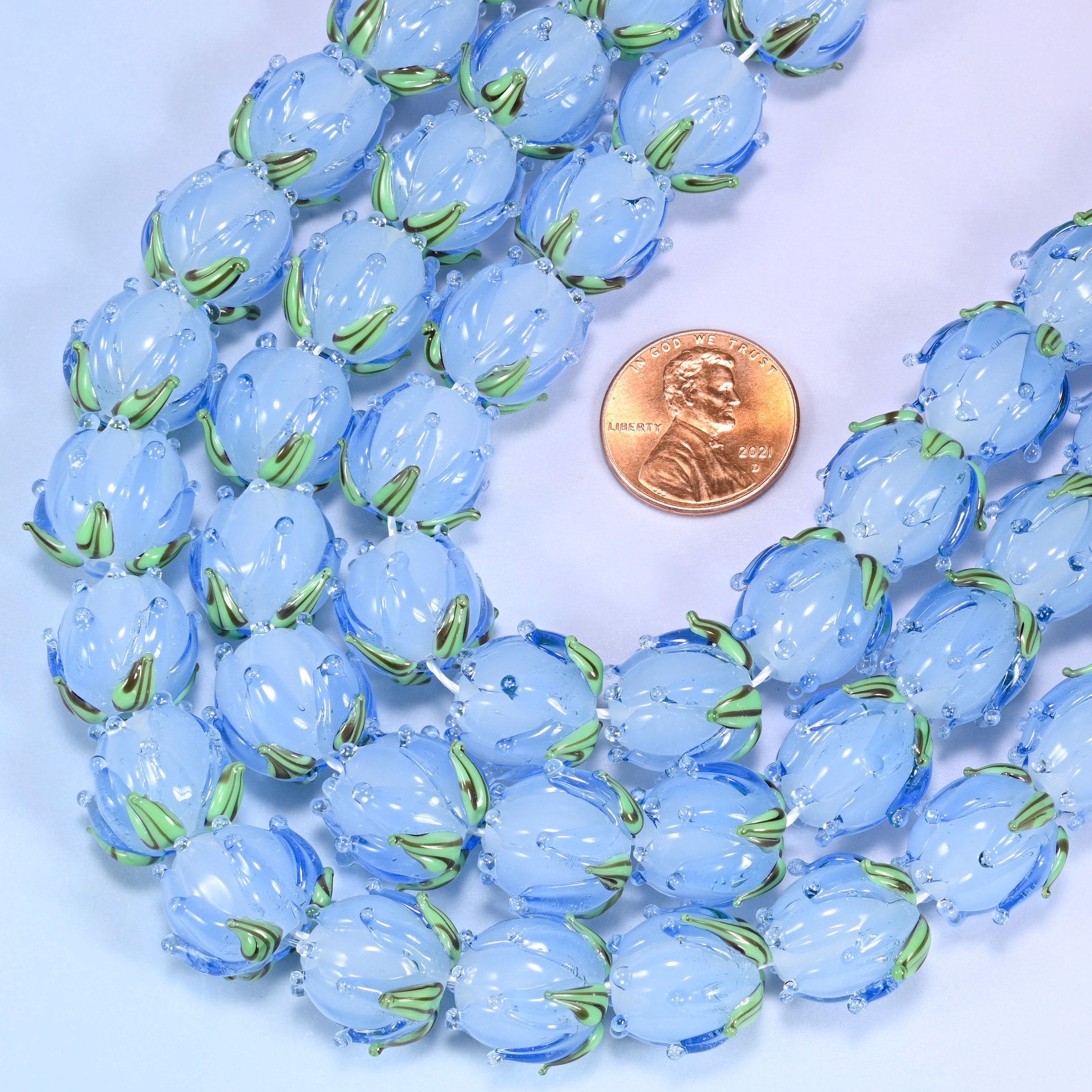 Tulip flower bud with leaf detail at the base cut lampwork glass beads